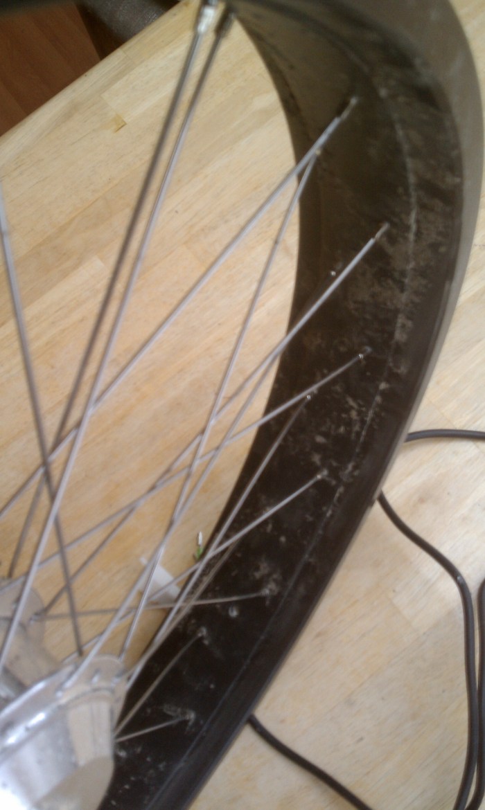 Crossing the spokes to the opposite side is the only way to offset the rim.